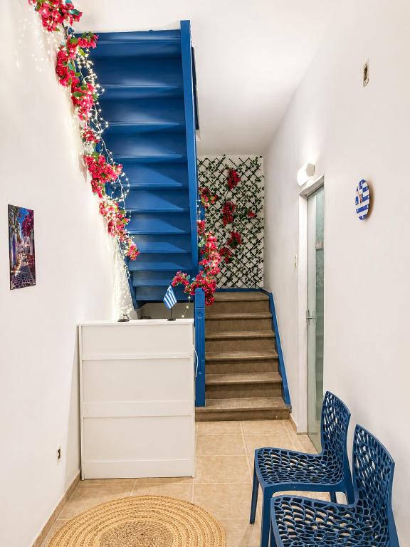 a staircase with a blue stair case and two chairs at Casa Mykonos Rio in Rio de Janeiro