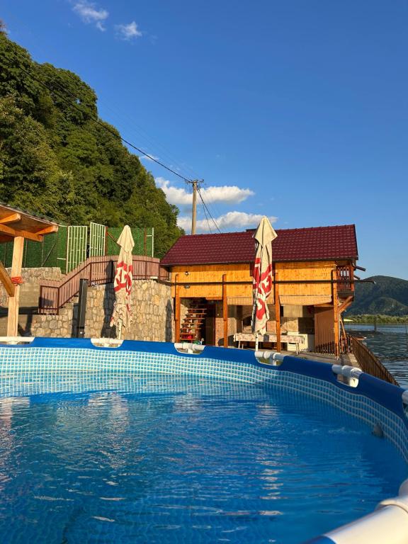 a swimming pool in front of a house at Lure House in Mali Zvornik
