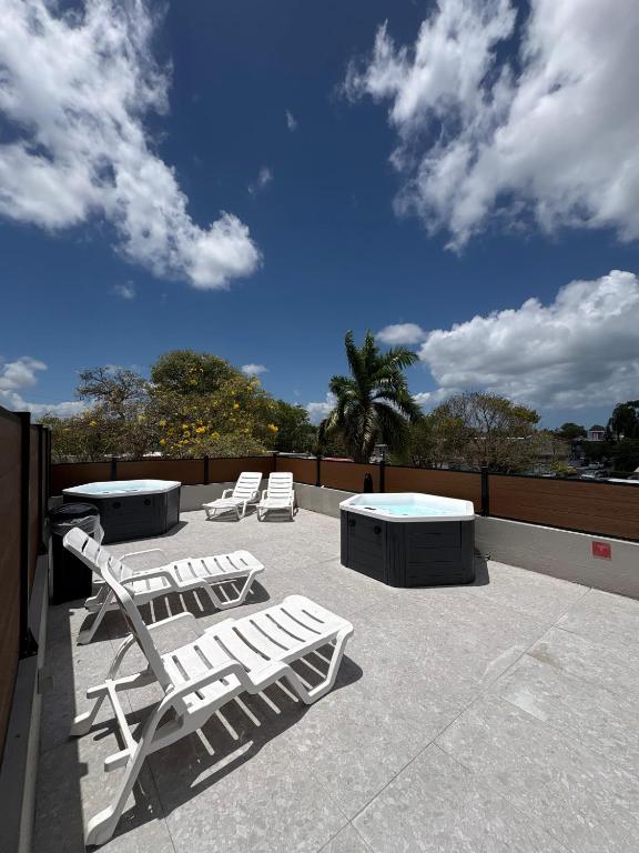 two lounge chairs and a table on a roof at Aura House Isla Verde in San Juan