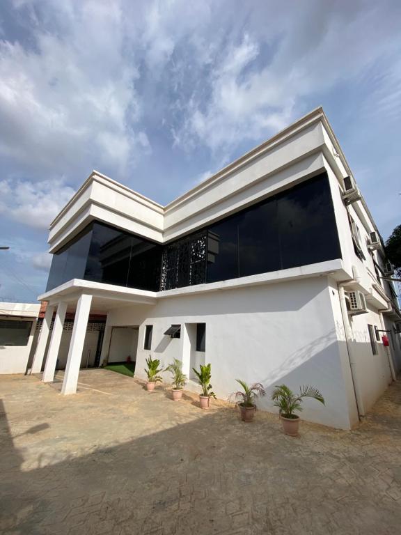 a white house with a large window at CZ Apartments in Bardon Yana