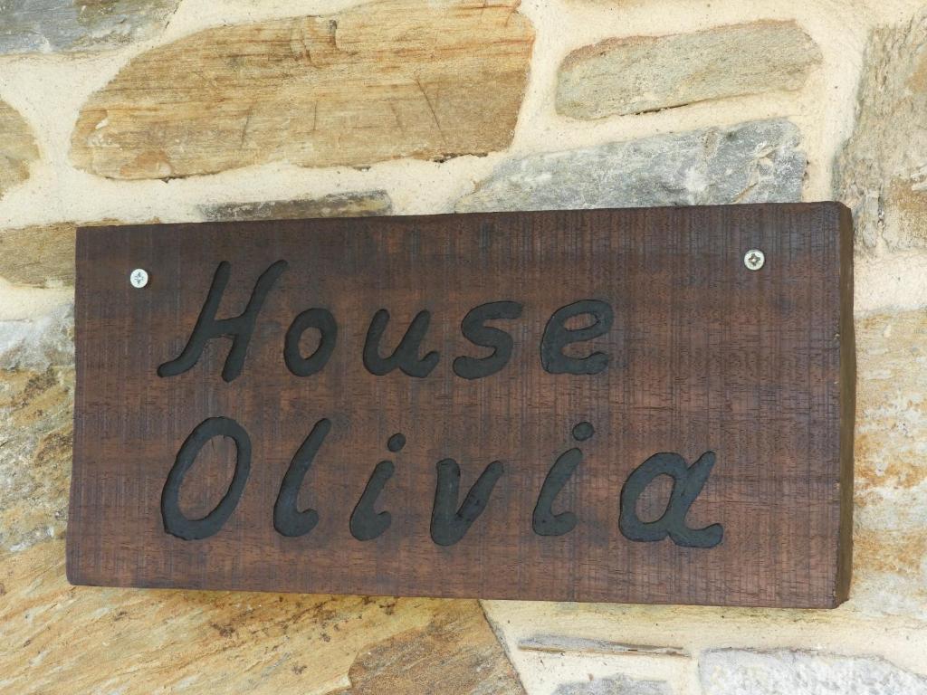 a house outlet sign on a stone wall at Olivia traditional stone house in Nikiti