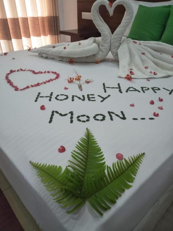 a cake with the words happy happy honeymoon on a bed at Reach Hotel & Restaurant in Kegalle
