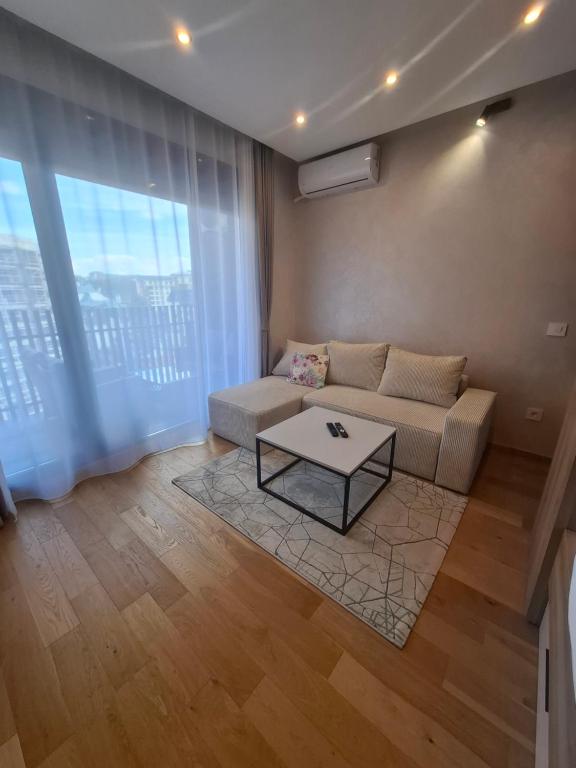 a living room with a couch and a table at Zlatibor 1 Balkan Square in Zlatibor