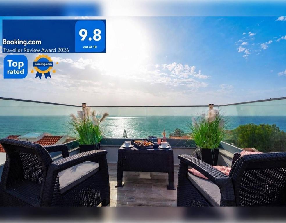 a view of a patio with chairs and a table at VILLA HELENA Crystal Apartment in Caniço