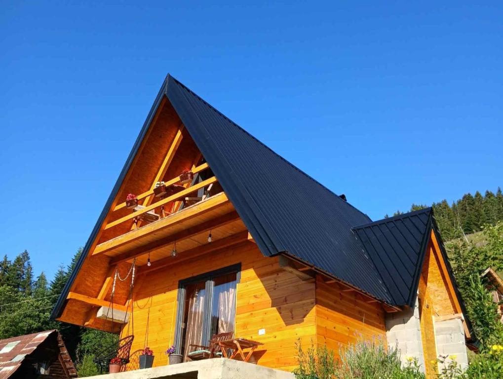 a log cabin with a black roof at Hasan's Place Temnjaci in Plav