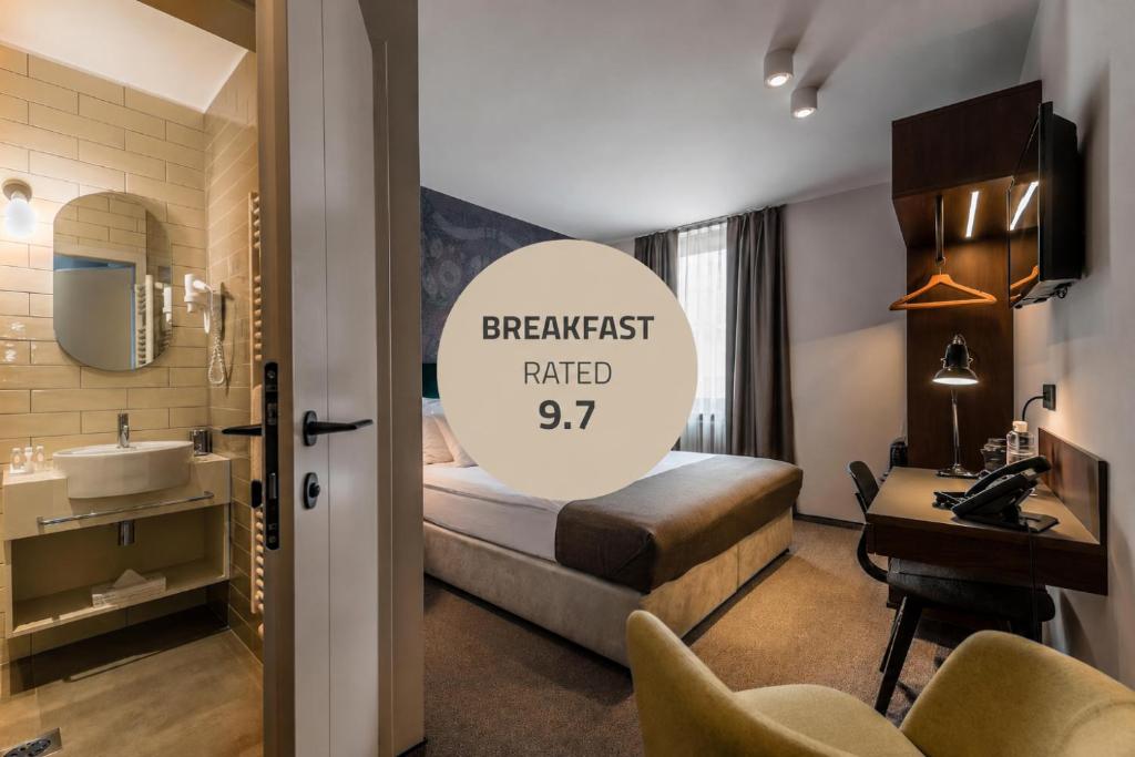 a hotel room with a bed and a sink at Hotel Mrak in Ljubljana