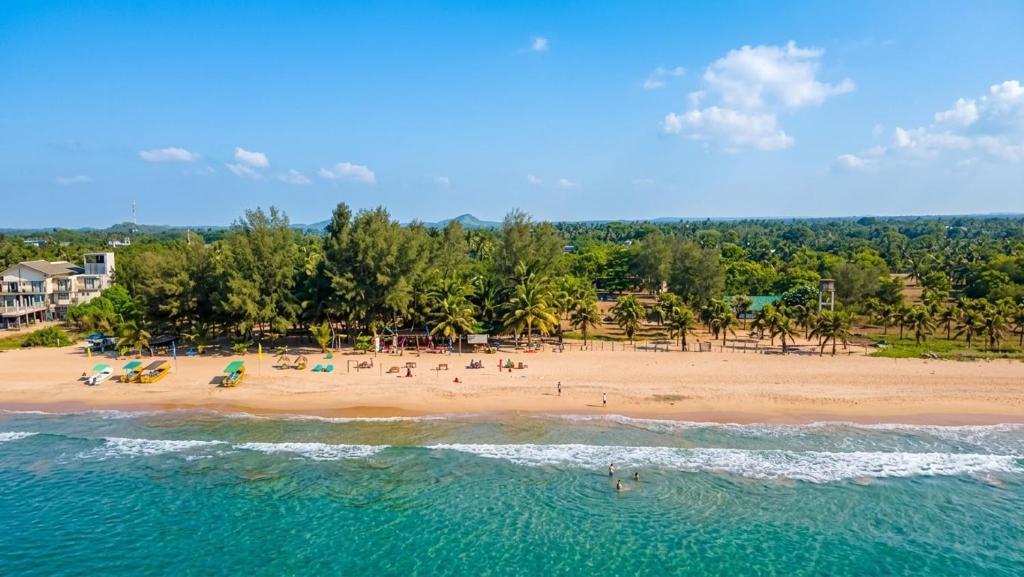 an aerial view of a beach with people on it at Happy Beach hotel nilaveli in Nilaveli