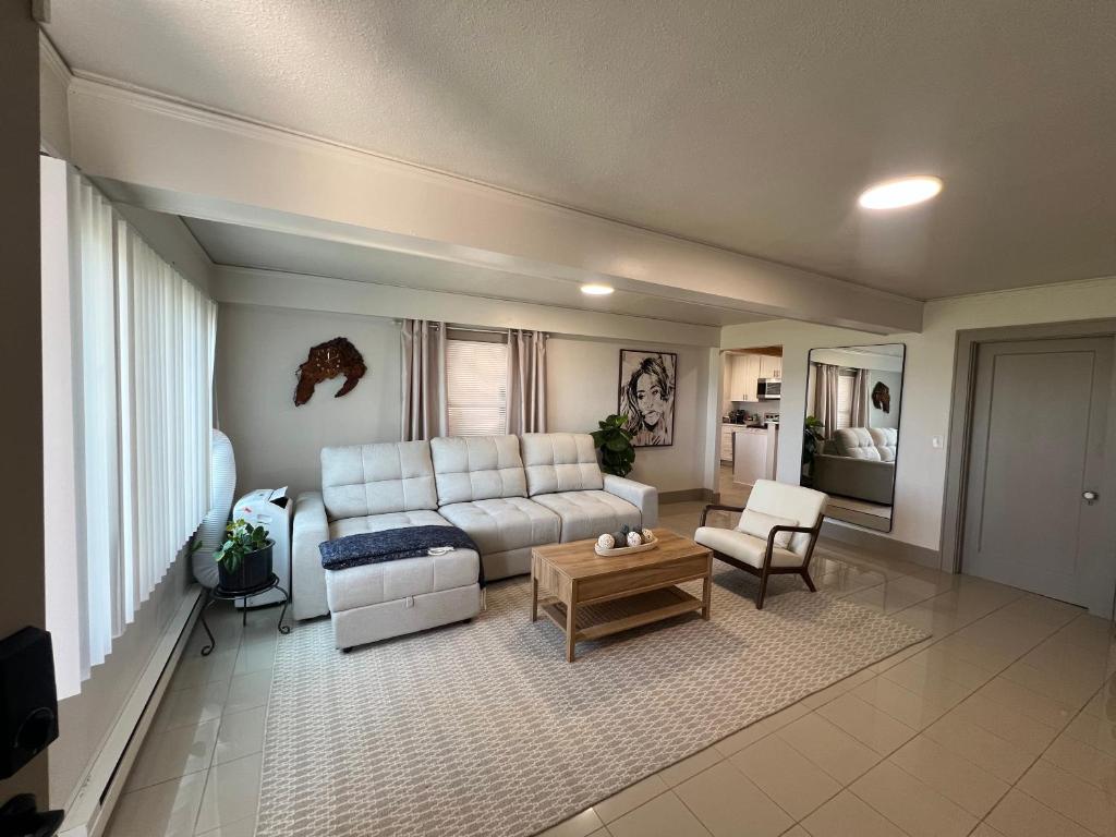 a living room with a white couch and a table at Alki Beach Nest in Seattle