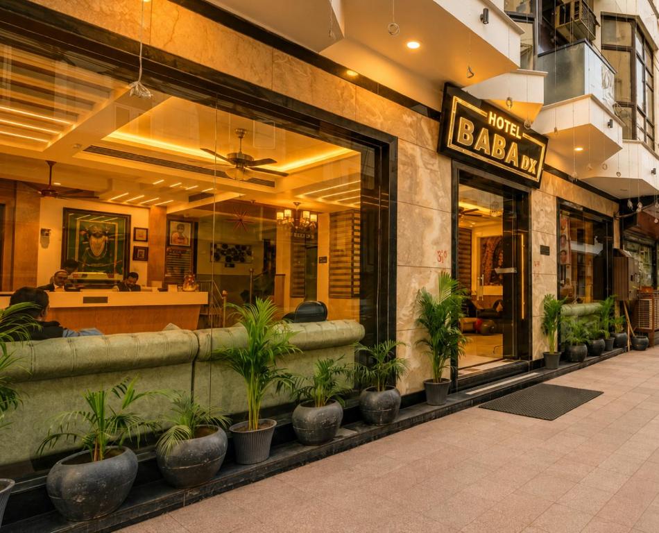 a restaurant with potted plants in front of a store at Hotel Baba Deluxe near New Delhi Railway Station and City Center -By RCG Hotels in New Delhi