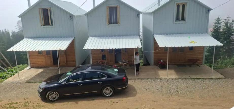 a black car parked in front of a house at Nino apartment in Dvabzu