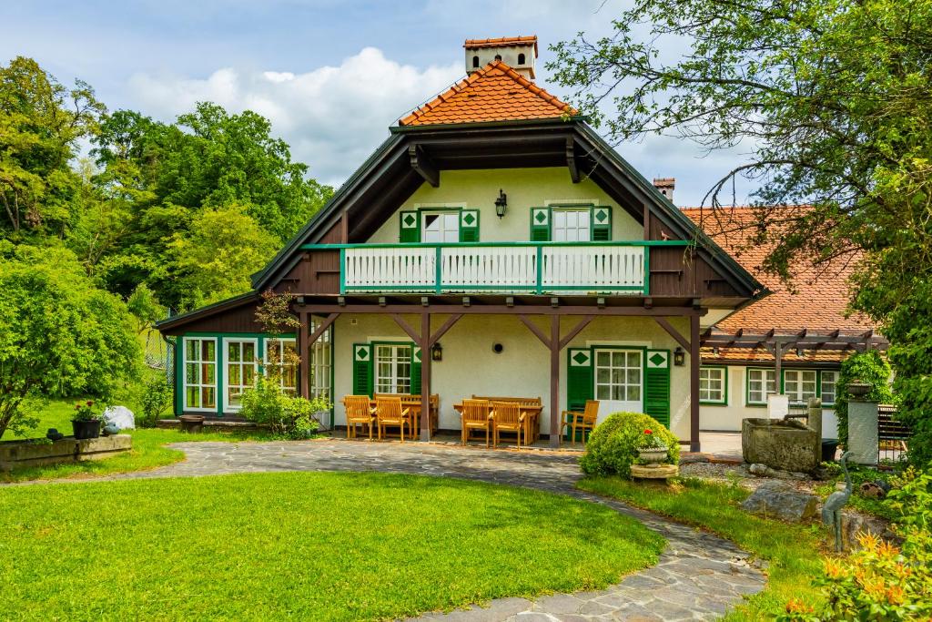 a house with a gambrel roof and a patio at Hirschenhof in Graz