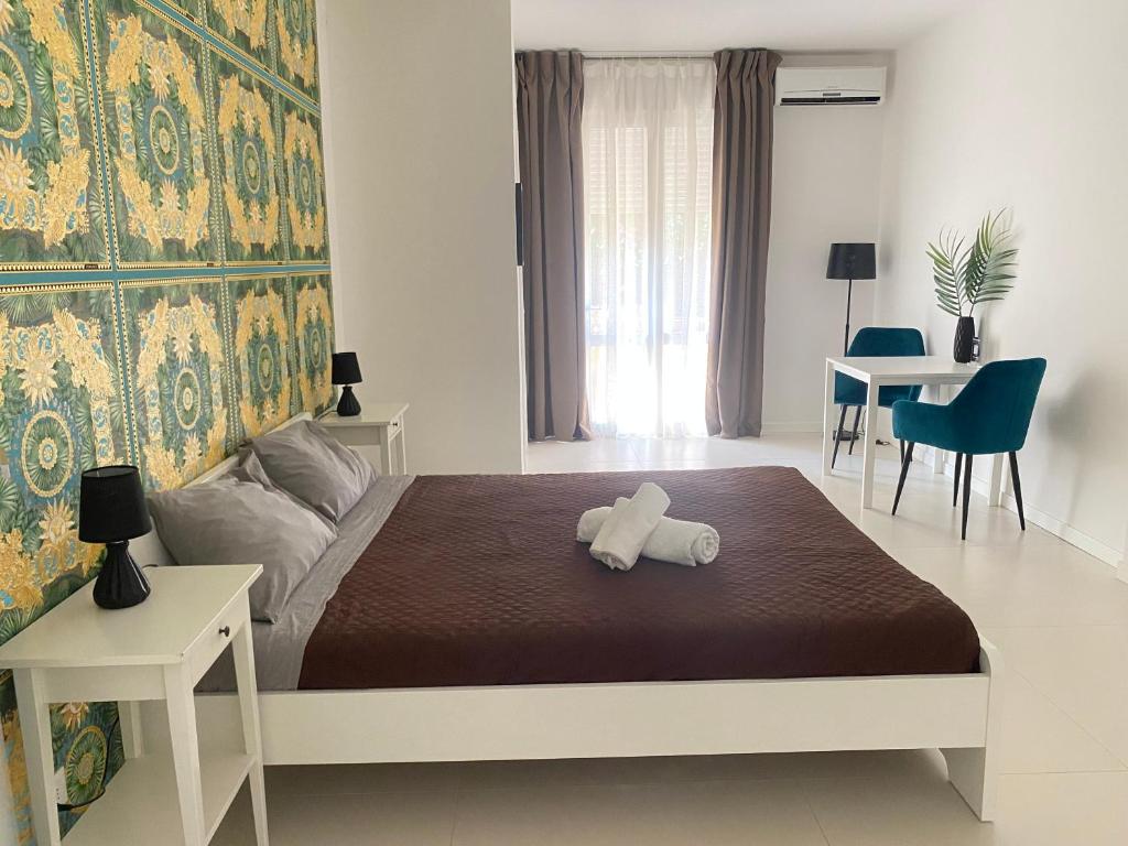 a bedroom with a bed with a teddy bear on it at Urban Suite- Holiday Rooms in Padova