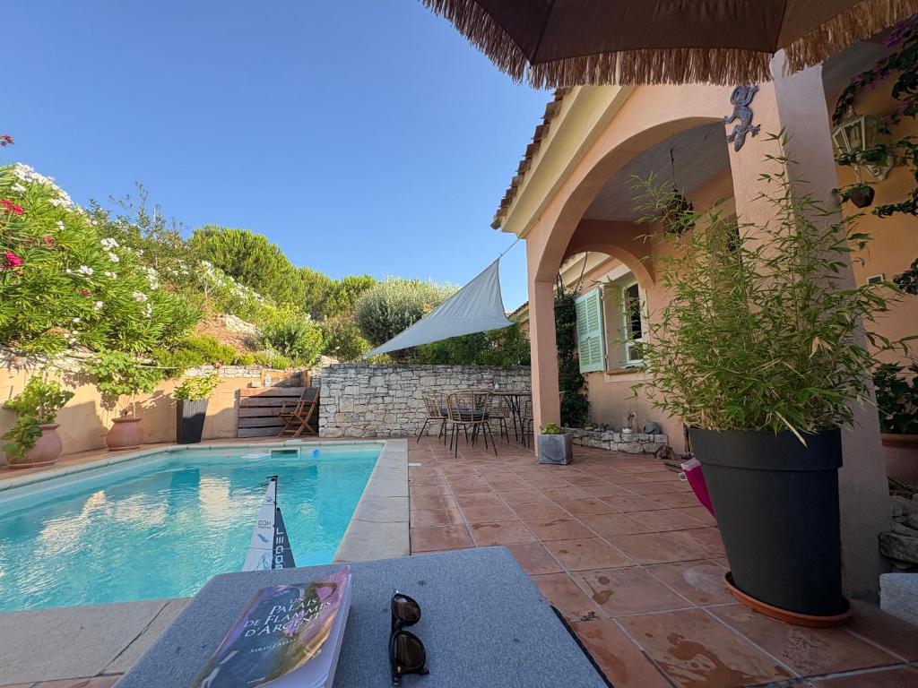 a villa with a swimming pool and a house at vue sur le golfe de Saint Florent in Saint-Florent