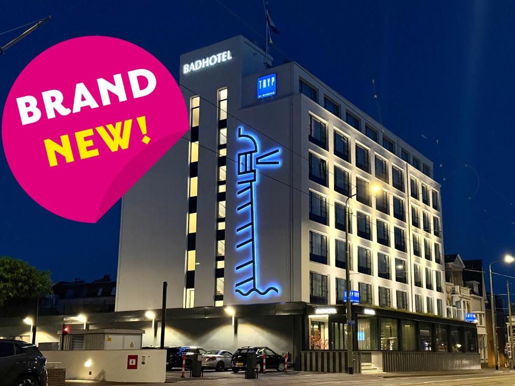 a building with a brand new sign in front of it at TRYP Badhotel The Hague Scheveningen BRAND NEW in Scheveningen
