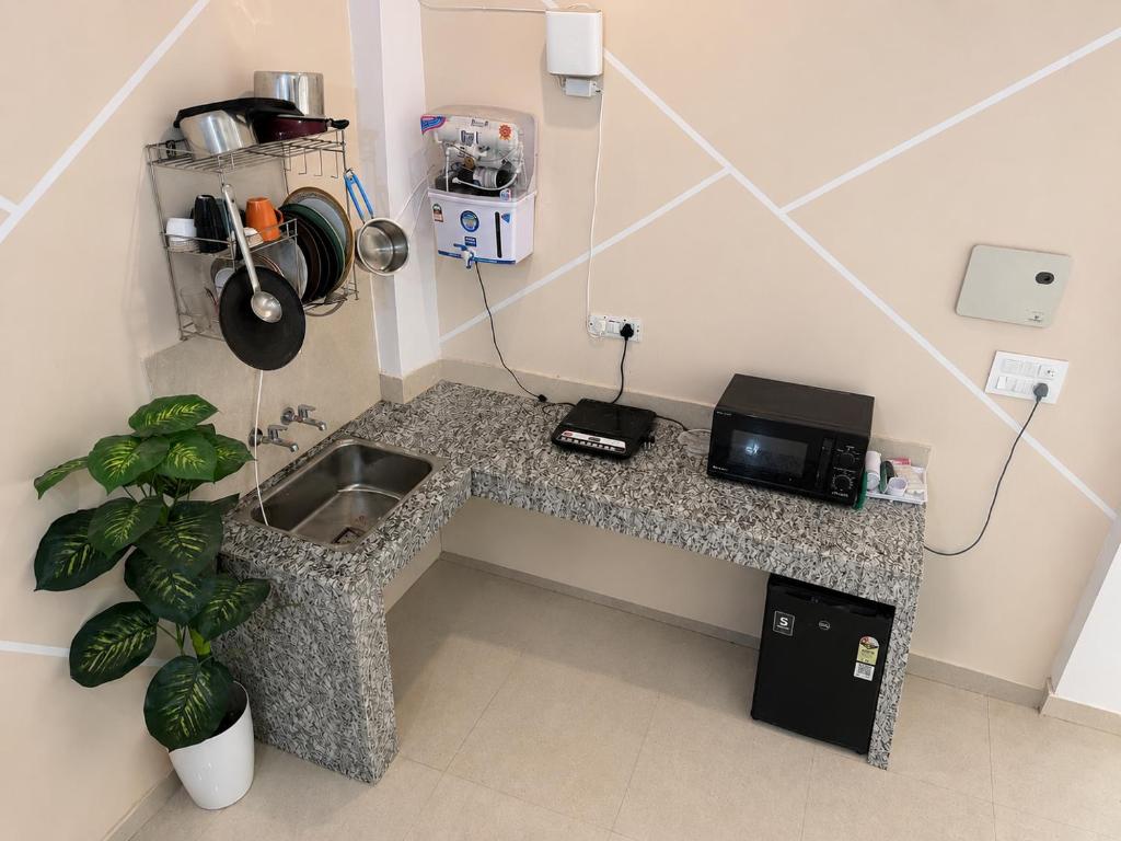 a kitchen with a sink and a counter top at Drip Home Stay AKTU in Lucknow