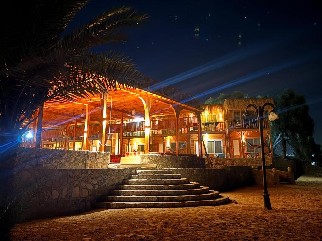 a building with stairs in front of it at night at Mermaid camp in Nuweiba