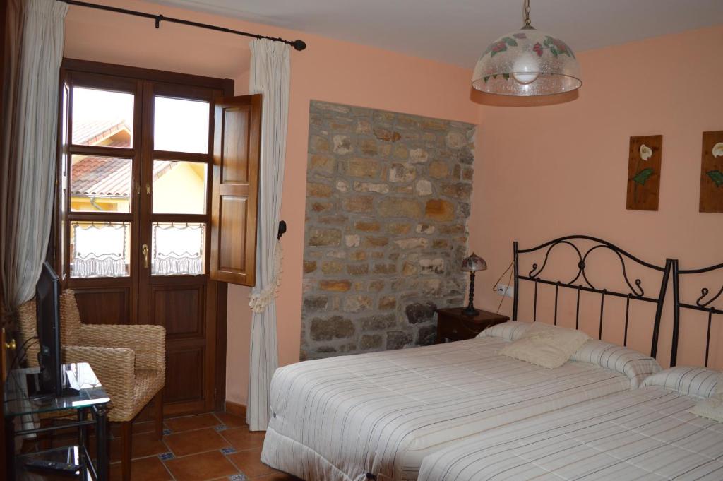 Postel nebo postele na pokoji v ubytování La Casona de Quintes