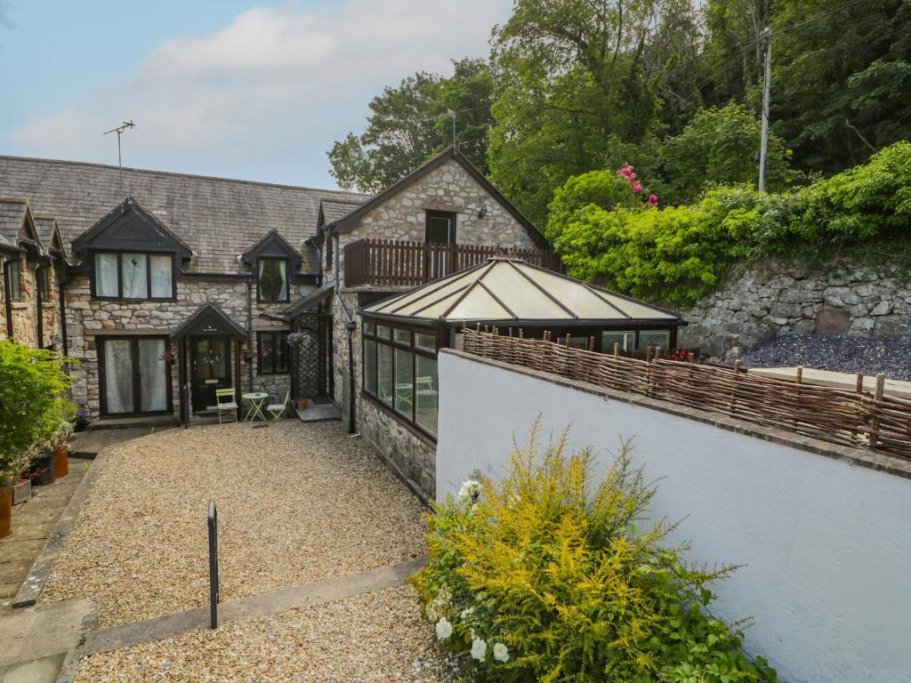 an exterior view of a house with a retaining wall at Ivy Cottage in Abergele