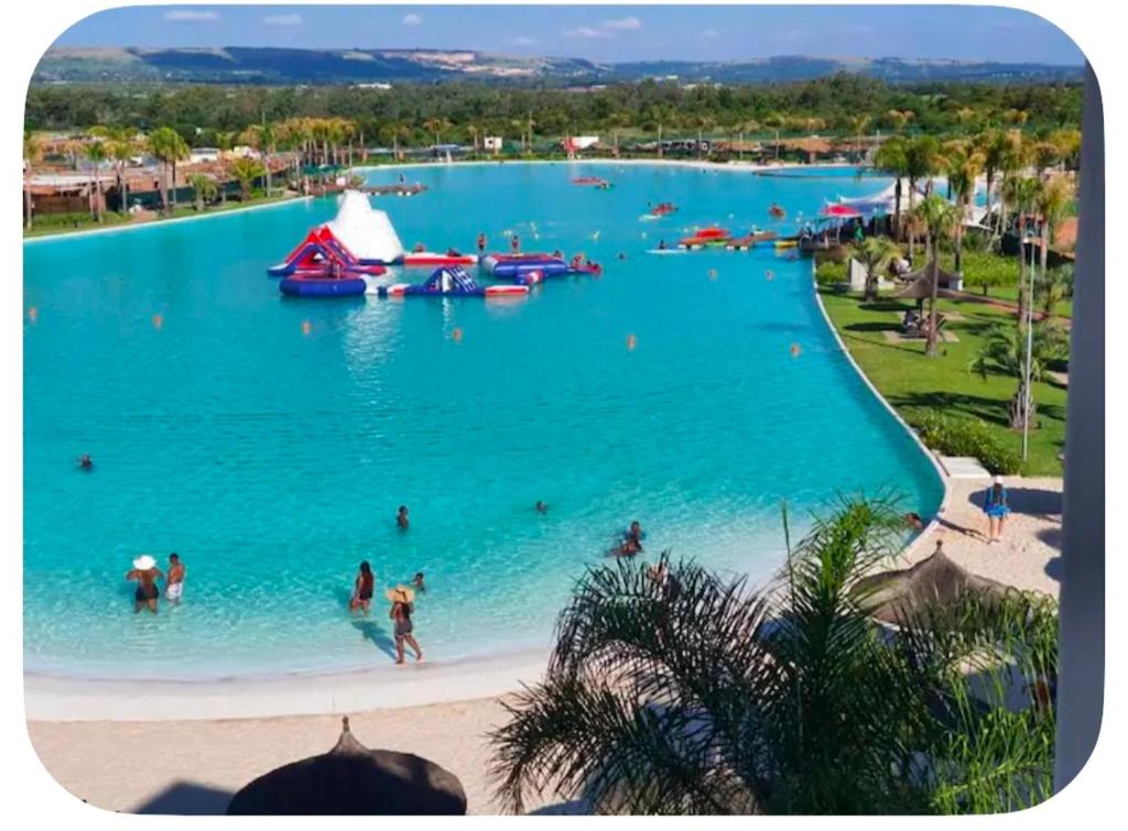 a group of people in the water at a water park at Aurevia Properties in Pretoria