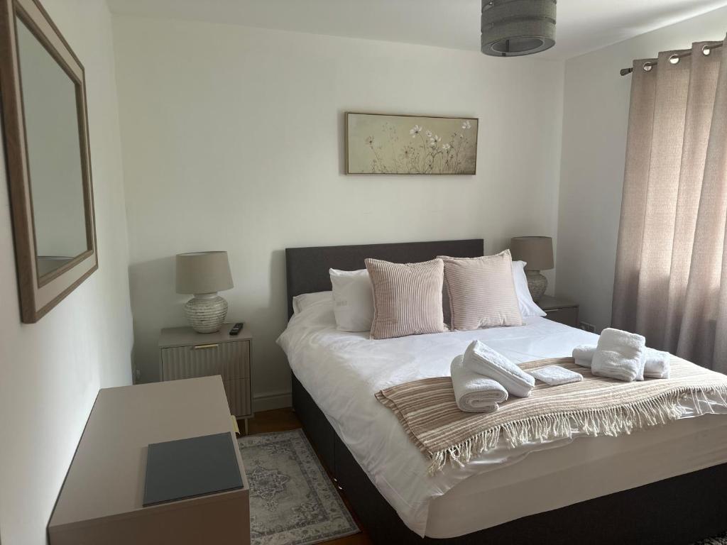 a bedroom with a bed with two towels on it at Northway Apartment's in Oxford