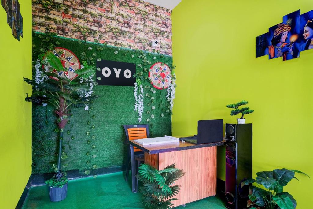 an office with a desk and a green wall at SPOT ON S.D.S GUEST HOUSE in Guwahati