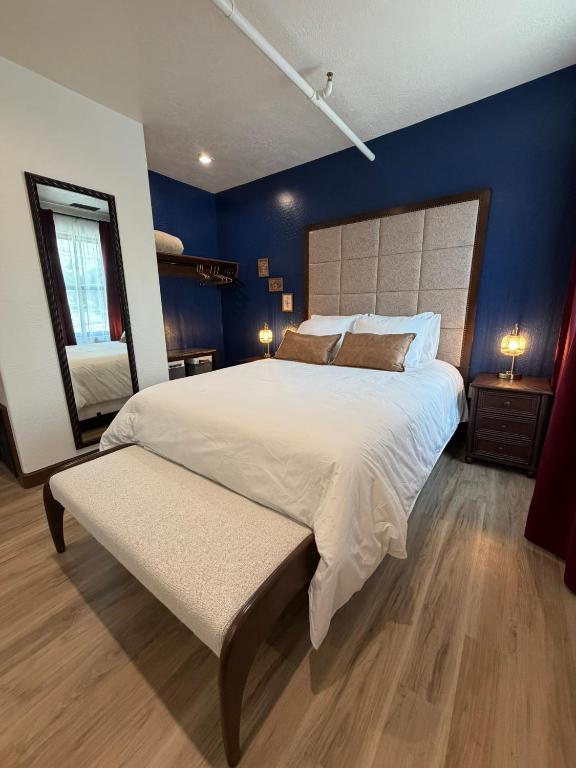 a large bedroom with a large bed with blue walls at Historic Tomahawk in Green River