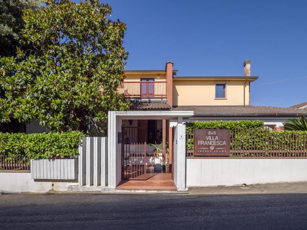 a building with a sign in front of a door at Villa Francesca Luxury Rooms in San Demetrio Corone