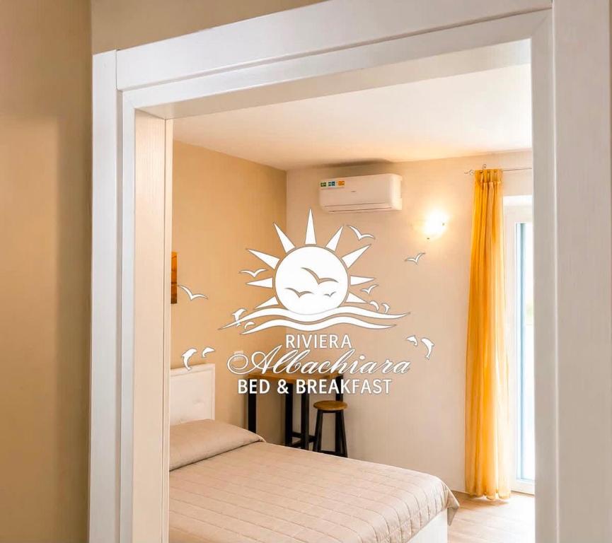 a bedroom with a bed with a sticker on the wall at Riviera AlbaChiara B&b in Anzio