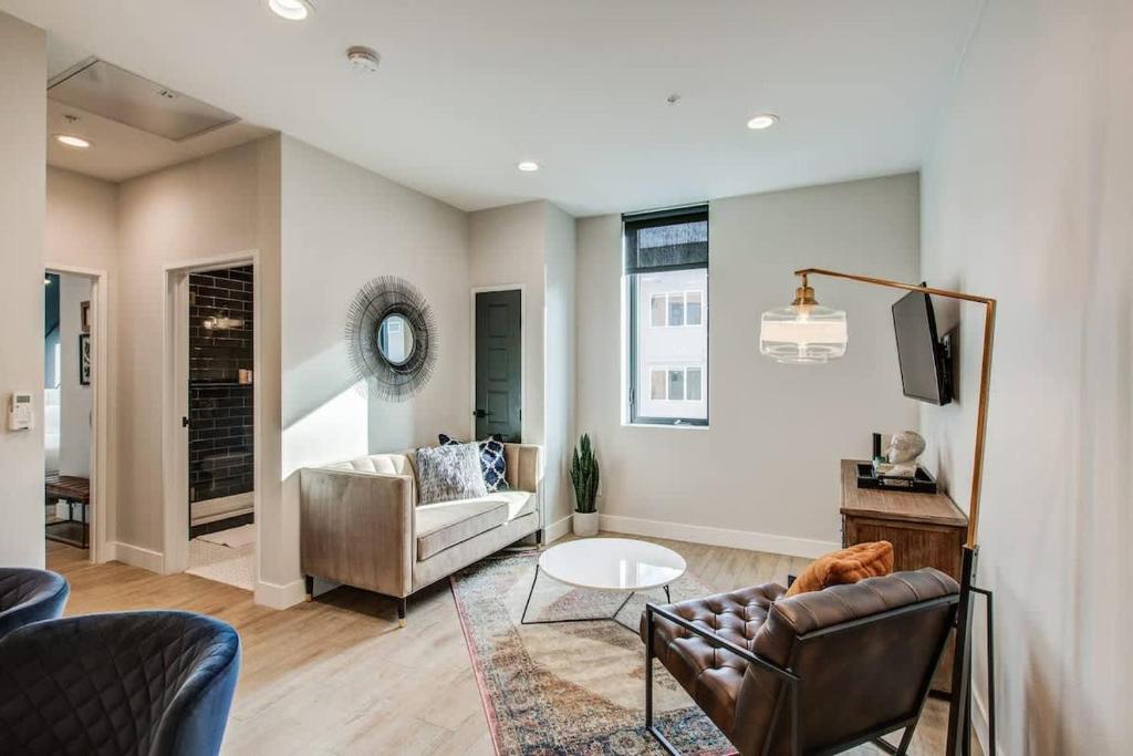 a living room with a couch and a table at Chic Tennyson St Retreat - Walk to Shops & Cafes in Denver