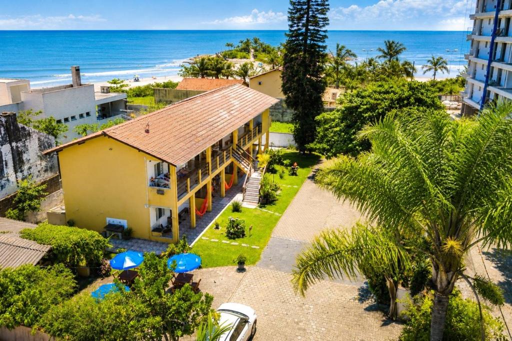 an aerial view of a house and the beach at Solar das Andorinhas Pousada in Itapoa