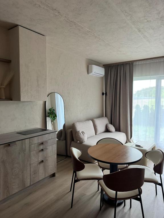 a living room with a table and a couch at Locusdo apartment Nr 27 in Vilnius