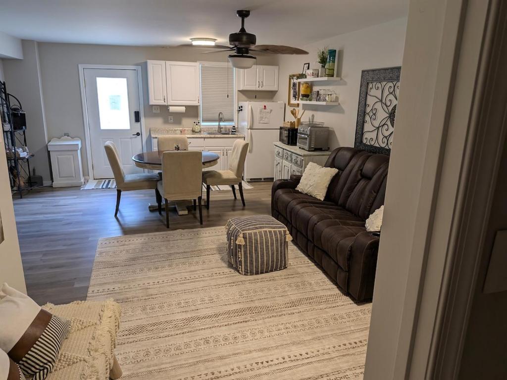 a living room and kitchen with a couch and a table at Cozy Hideaway guest suite in Midlothian