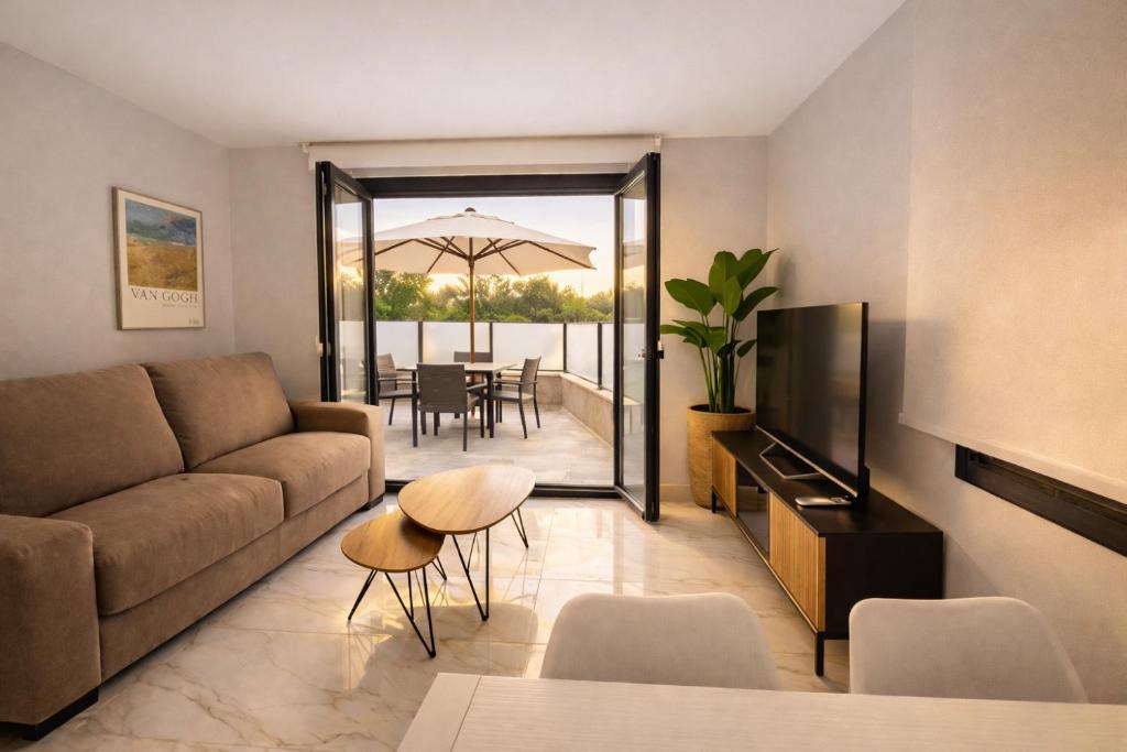 a living room with a couch and a television and a table at O Lar de LUCI in Nigrán