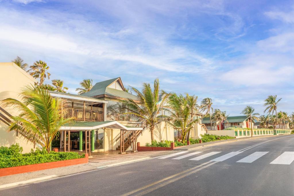 a street view of a resort with palm trees at Decameron San Luis - All Inclusive in San Andrés