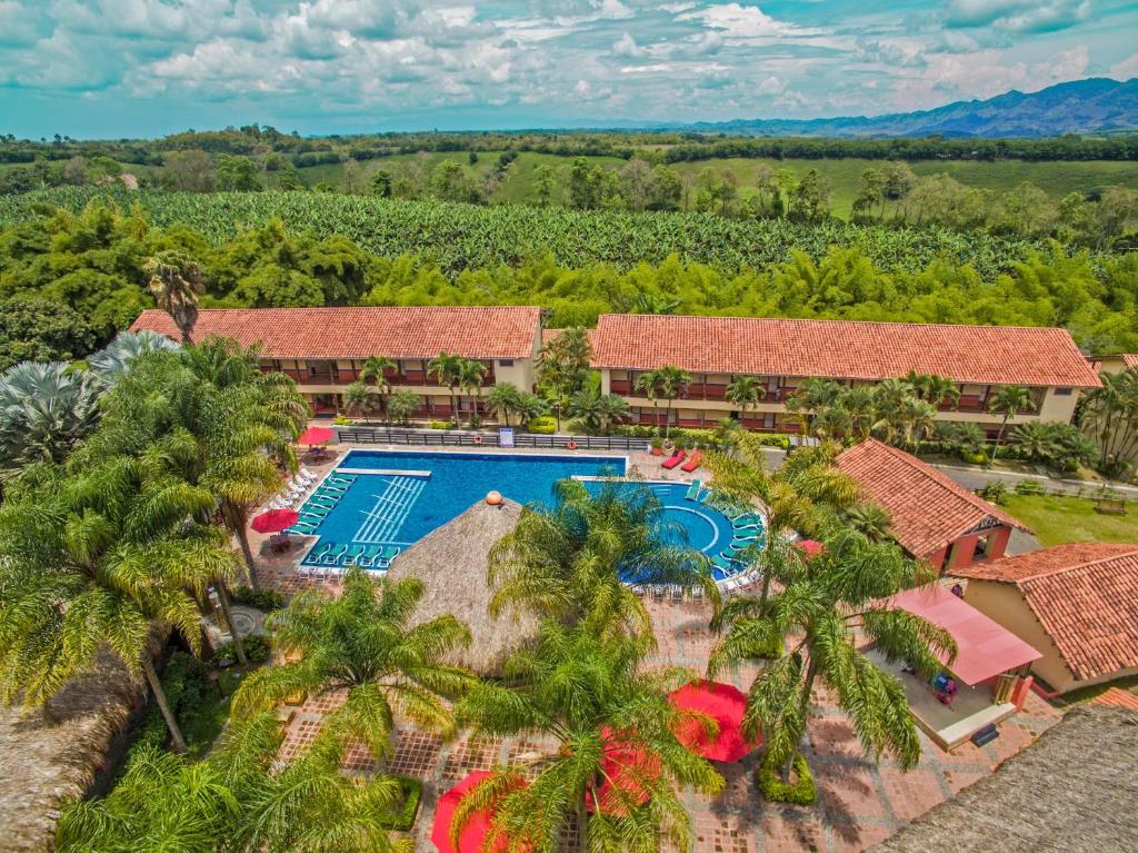 an aerial view of a resort with a pool and palm trees at Decameron Panaca - All Inclusive in Quimbaya