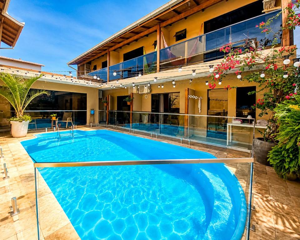a swimming pool in front of a house at Pousada Casa Da Praia in Florianópolis