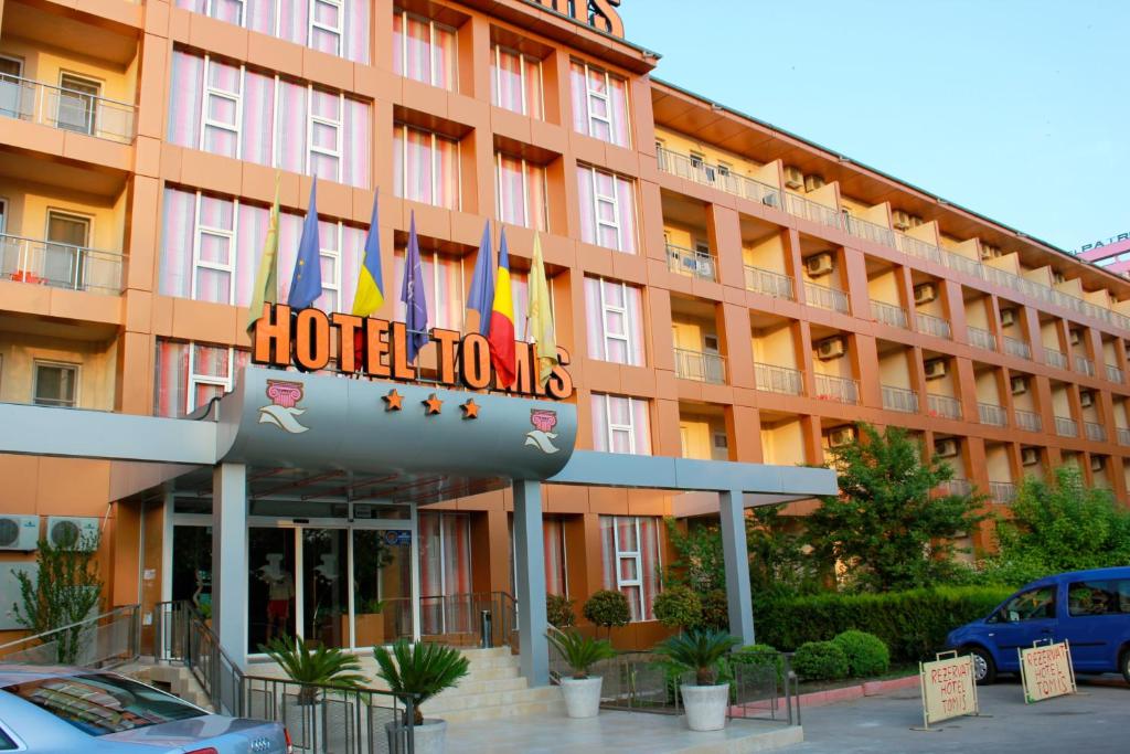 a hotel with flags in front of a building at Hotel Tomis in Mamaia