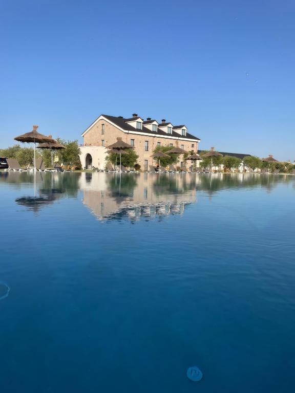 a large building sitting on top of a large body of water at Clean City Agrotourism in Durrës