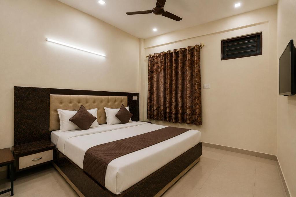 a bedroom with a large bed and a window at Hotel Galaxia Inn Near PEC College in Chandīgarh