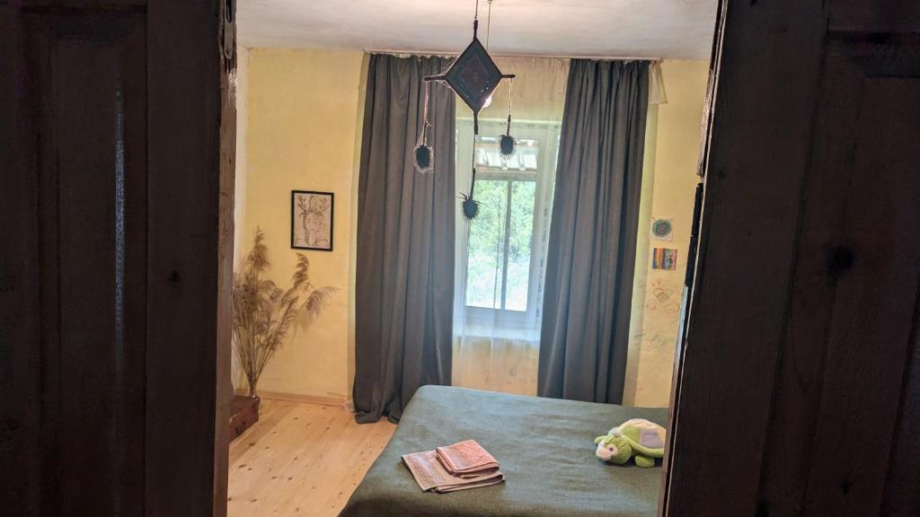 a reflection of a bedroom with a bed and a window at Guest house in Ipnari