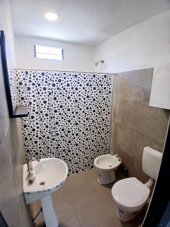 a bathroom with a sink and a toilet at Hospedaje Cosquin in Cosquín