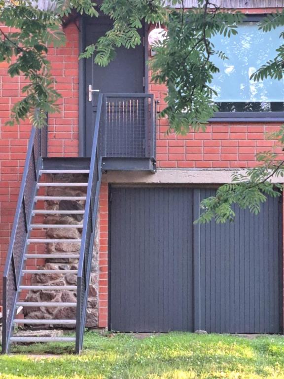 a staircase leading up to a building with a gate at Amber in Ragaciems