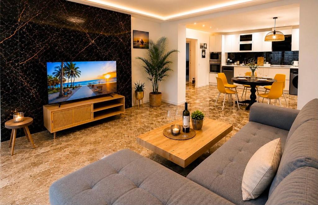 a living room with a couch and a flat screen tv at Del Mar Modern Spacious 3-Bedroom Apartment Near the Beach in Puerto de Sagunto