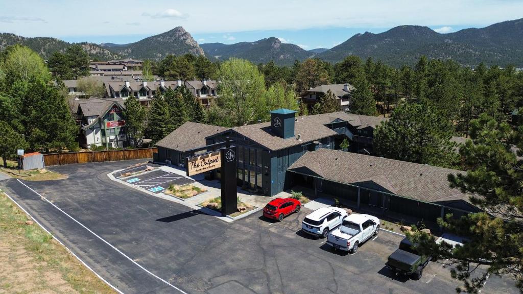 an aerial view of a building with cars parked in a parking lot at The Outpost Rocky Mountains in Estes Park