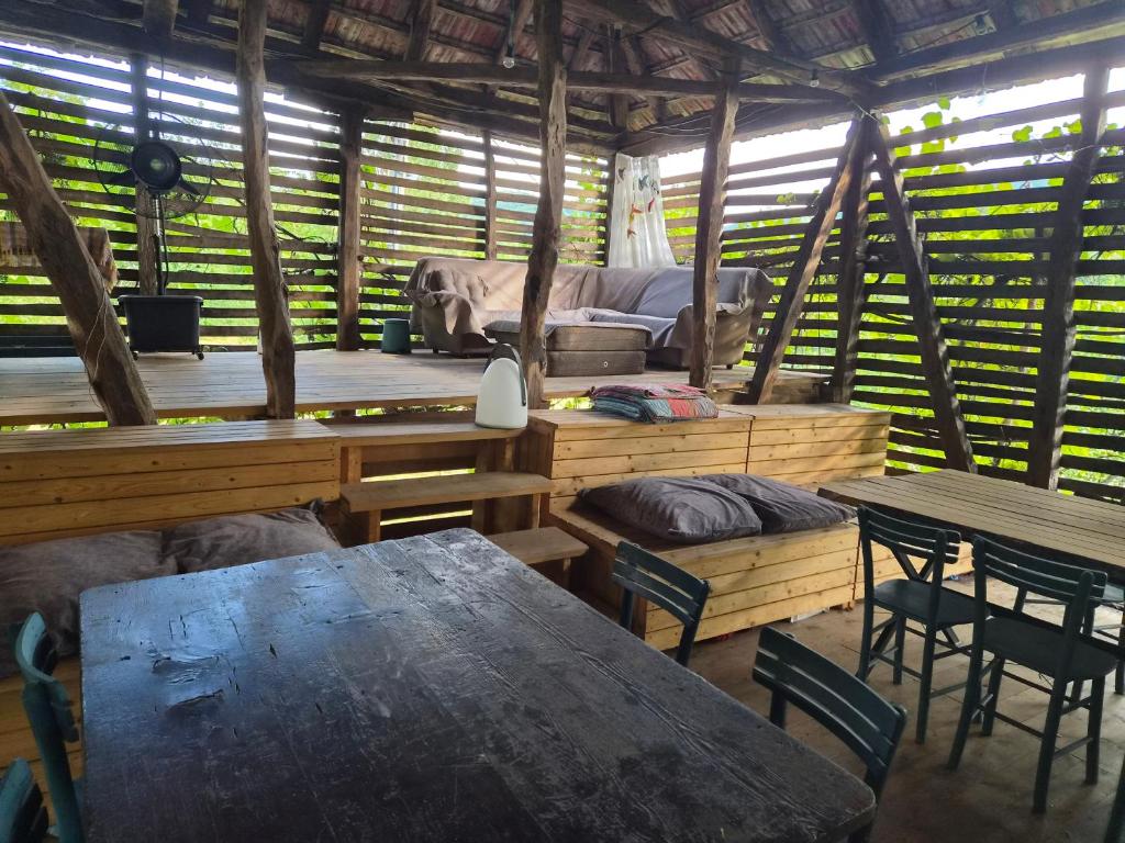 a room with tables and chairs and a couch at Kamp Kalavat in Vrtovac