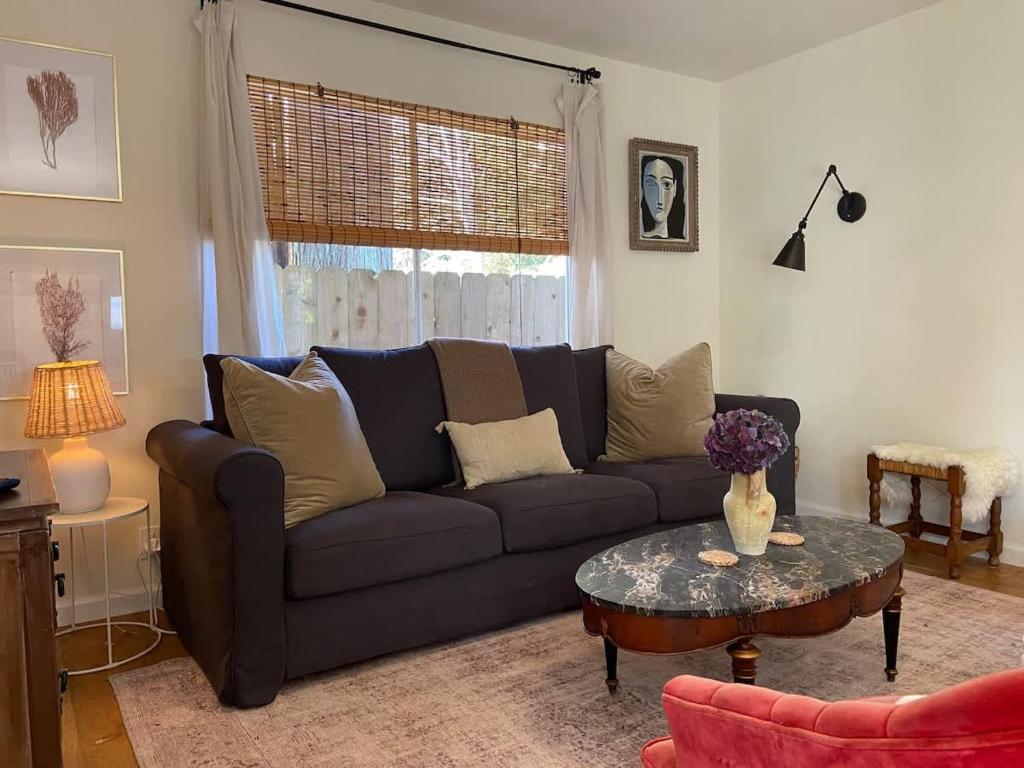 a living room with a couch and a table at Rock Rose Cottage in Trinidad