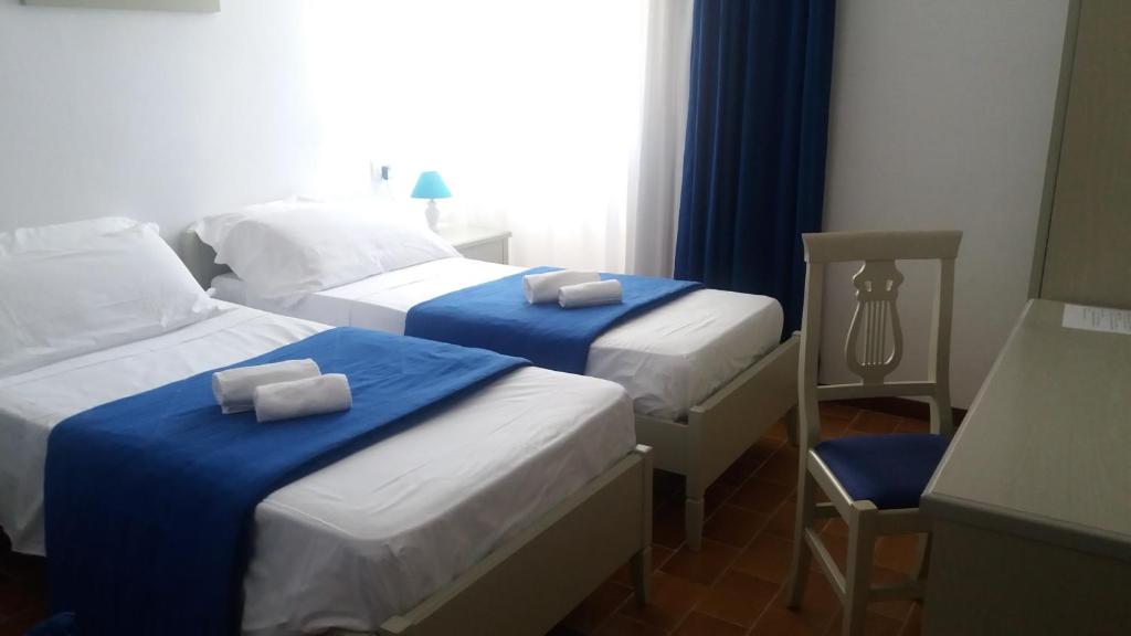 Postel nebo postele na pokoji v ubytování Albergo Dei 10 Colori