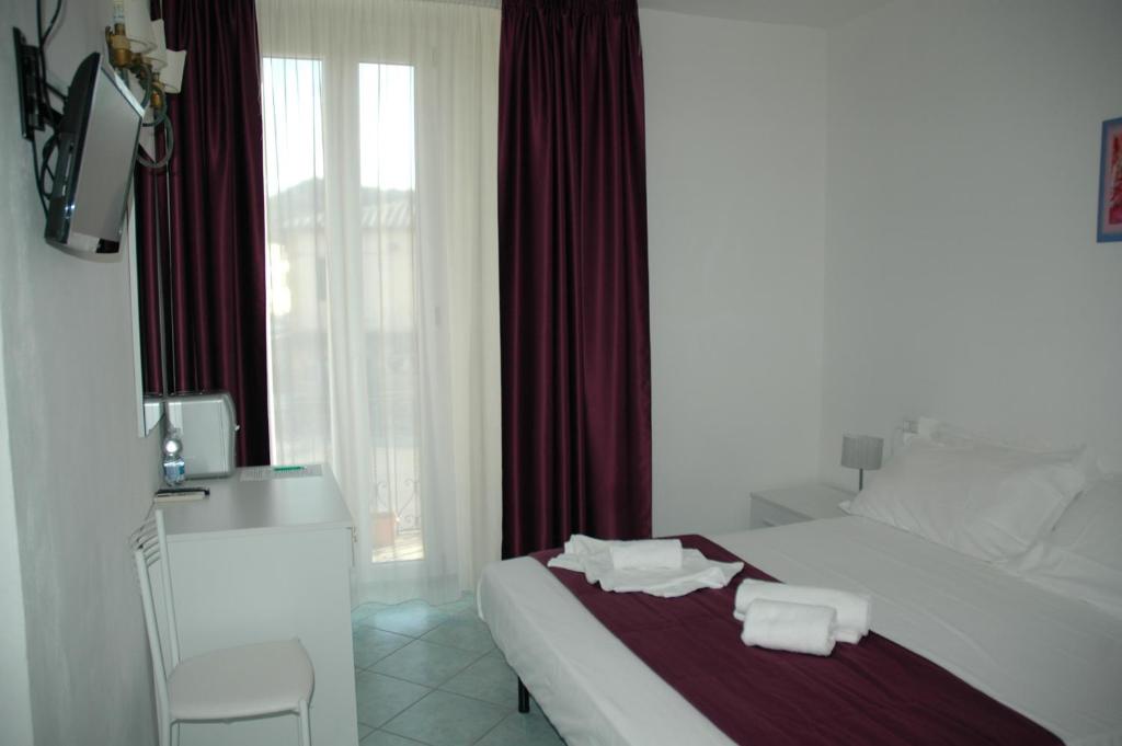 Postel nebo postele na pokoji v ubytování Albergo Dei 10 Colori