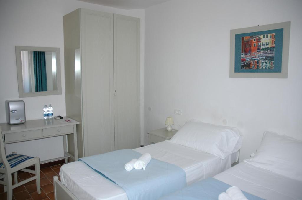 Postel nebo postele na pokoji v ubytování Albergo Dei 10 Colori