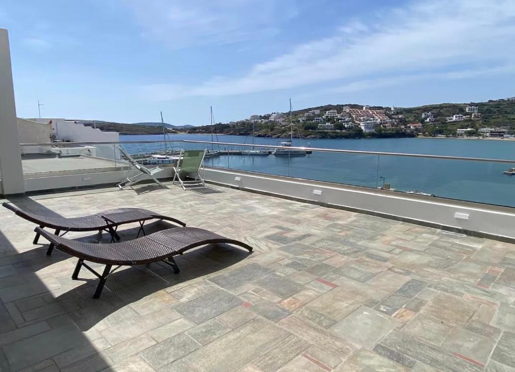 a balcony with a bench and a view of the water at Luxury Maisonet Veranda View Batsi in Batsi
